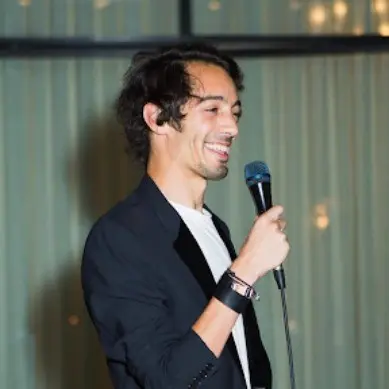 A man speaking into a microphone at an event
