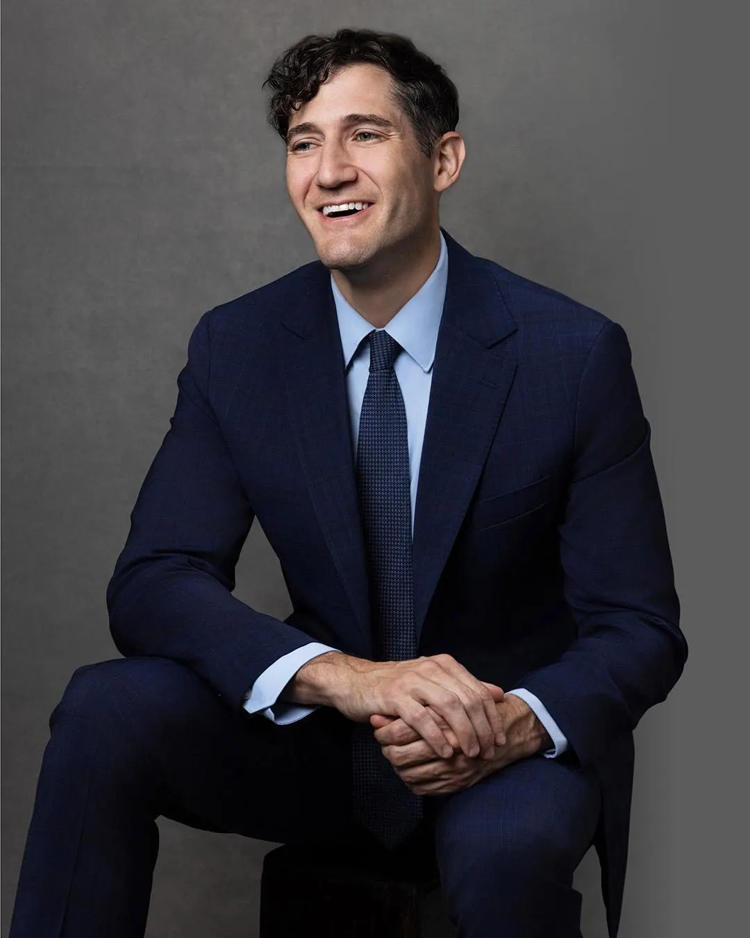 Govra CEO Josh Sandler smiling in a navy suit