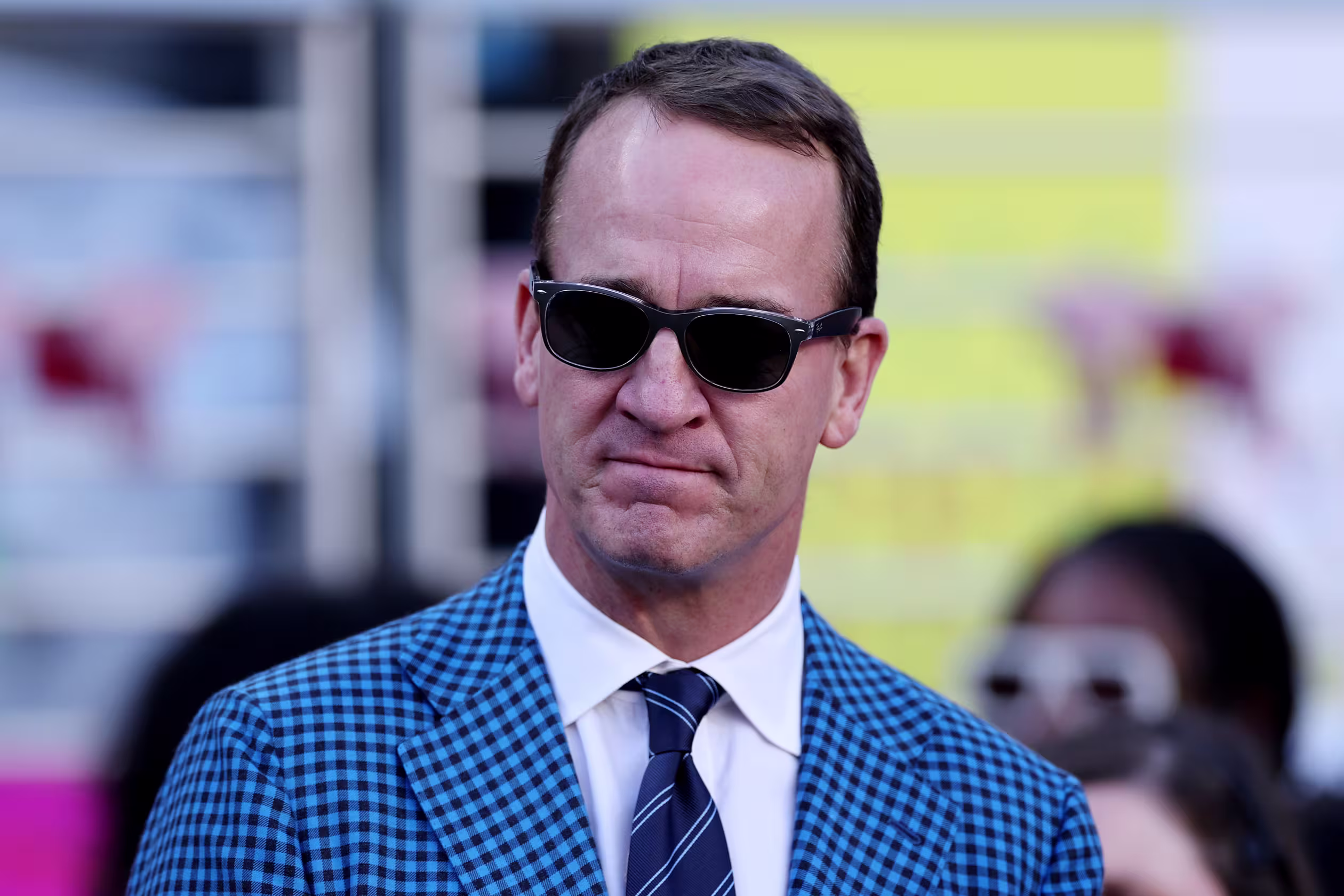 Peyton Manning smiling in a formal setting