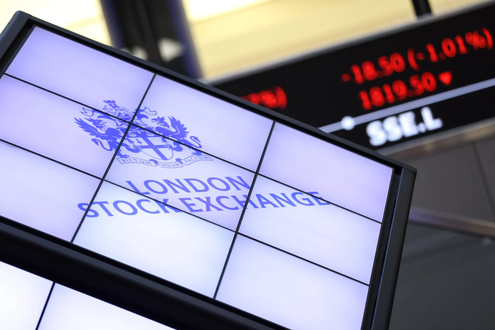 Traders working at multi-monitor desks on a trading floor