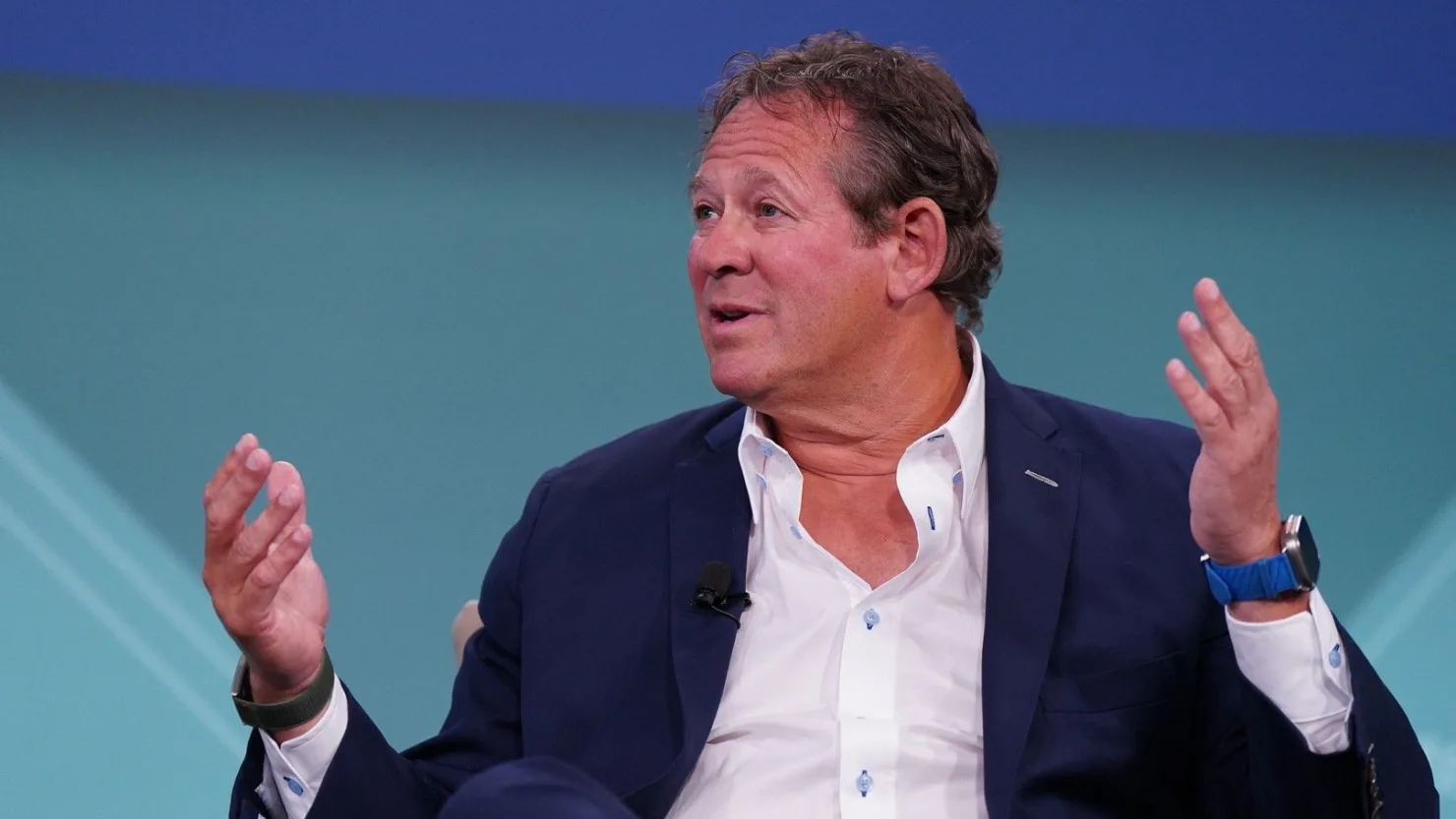 Rick Rieder gesturing while speaking during a television interview